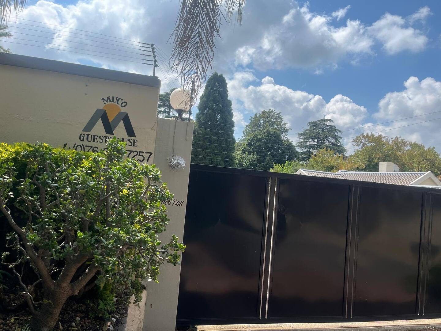Muco Guesthouse signage at the property gate