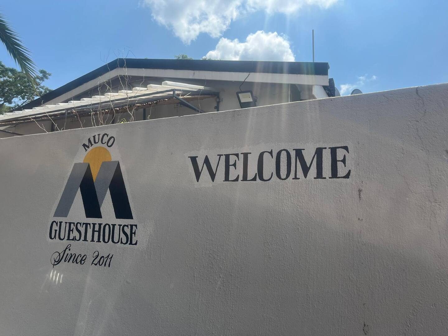 The Muco Guesthouse welcome wall at the entrance